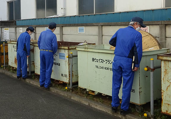 Employees carefully sort waste in order